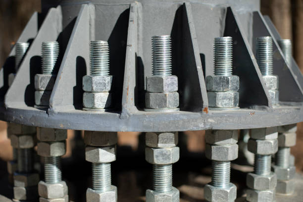 istock Nuts on bolts. Base of communication pole. Steel structural elements. 1398550736