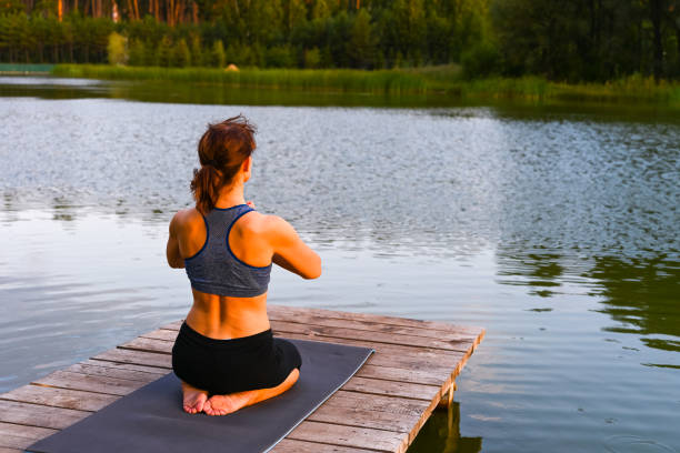 istock A woman stretches her muscles in nature. Physical activity concept. 1398550784
