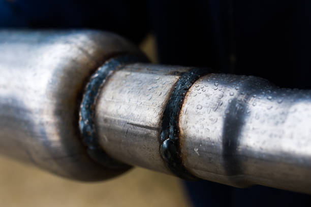 istock welding seam of a muffler for a car, close up 1398551649