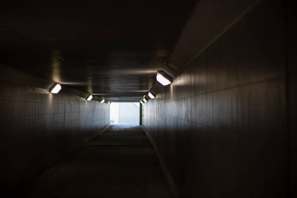 istock Tunnel with lamps. Long tunnel in building. 1398552287