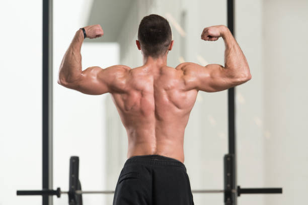istock Muscular Man Flexing Muscles In Gym 1398555375