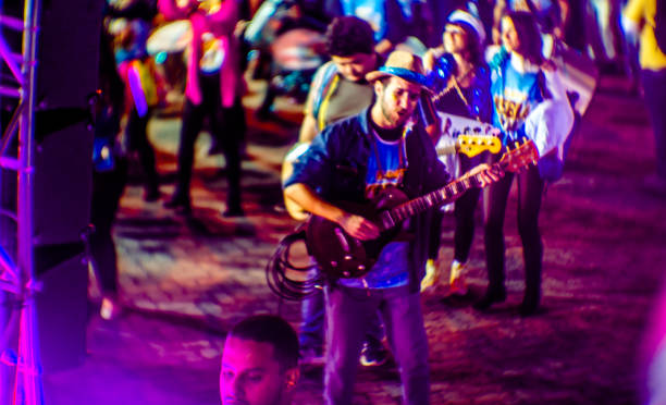 Carnival after the coronavirus pandemic opened on Friday night, May 20, in Vila, in Ilhabela, São paulo, Brasil. Despite the cold, blocks paraded down the avenue, infecting the public with excitement. Photos made with selective focus, large aperture lens.