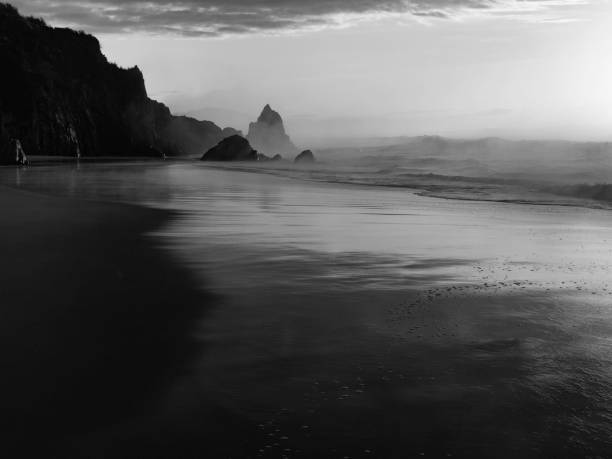 Black and white long exposure beach sunrise stock photo