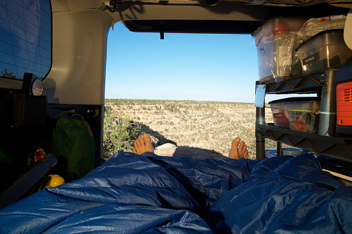 Open tailgate with bedding in overlanding vehicle