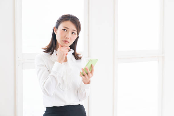 attractive asian woman to see a smart phone,think