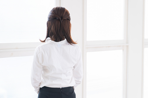 young attractive asian businesswoman , back