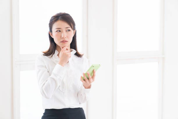 istock attractive asian woman to see a smart phone,think 1398562936