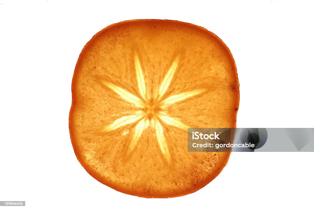 Shazza Close up of a slice of sharon fruit isolated Fruit Stock Photo