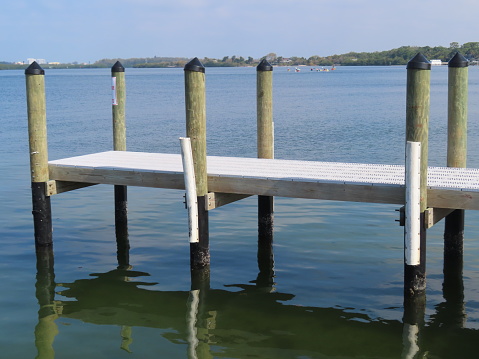 Wooden and metal jetty over calm water