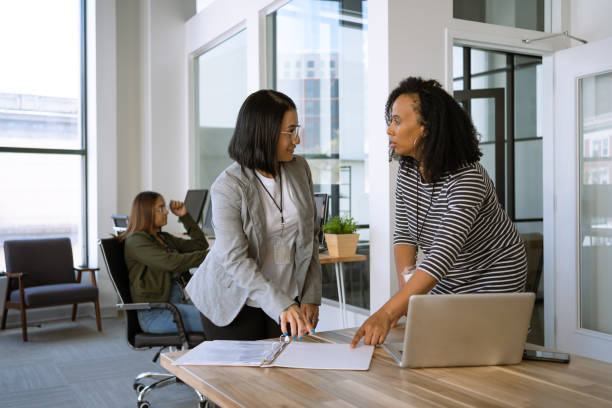 istock Woman interacting with a coworker at the office 1398578015