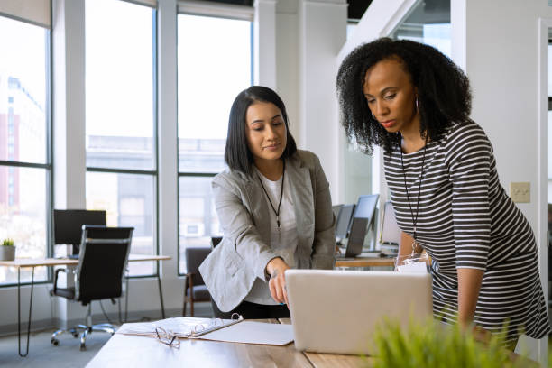 istock Woman interacting with a coworker at the office 1398578021