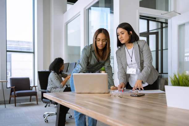 istock Woman interacting with a coworker at the office 1398578045