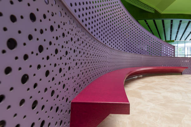 A spiral shaped color perforated metal staircase.This scene is located in the Sunshine Youth Activity Center, Putian City, Fujian, China