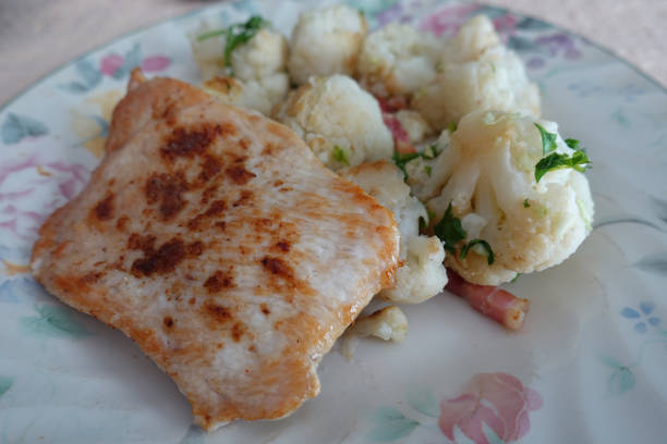 Turkey breast fillet cooked with spices served with cooked cauliflower