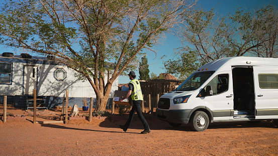 Delivering man walking with packages in Monument Valley - Utah