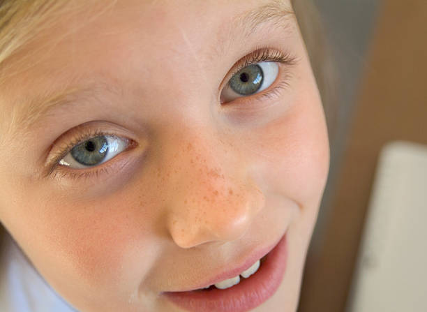 istock young girl looking up from her schoolwork 139858452