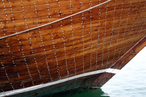 Wooden hull of a dhow on Dubai creek, United Arab Emirates.