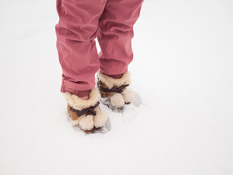 Little Girl Standing on Snowfield