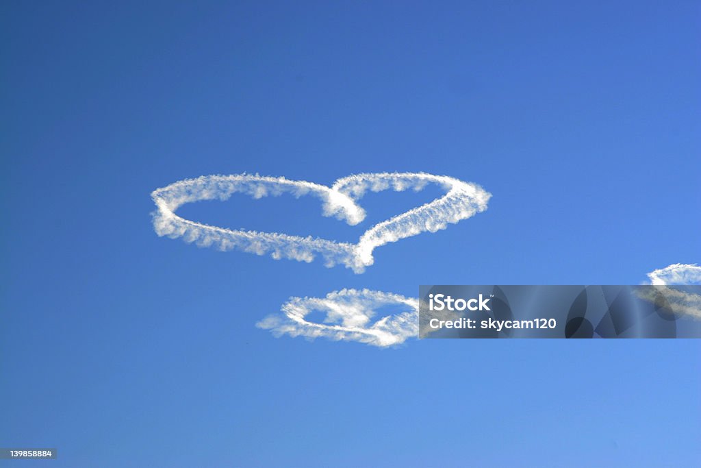 Valentine Clouds Skywriter creating hearts on Valentine's Day Skywriting Stock Photo