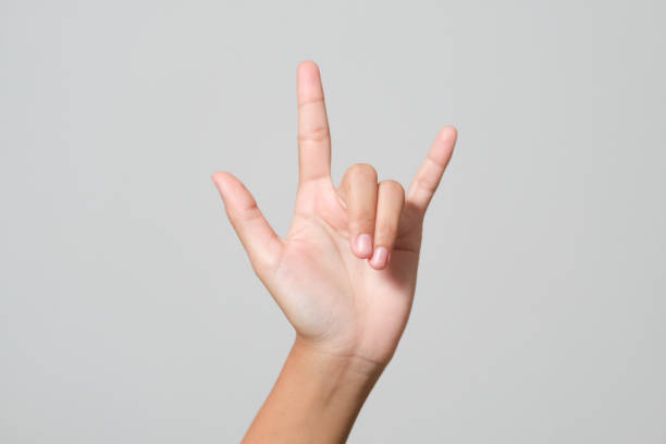 istock Woman's hand giving the Rock and Roll sign, devil horns gesture 1398589013