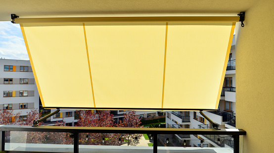 Balcony with awning opened, covered by sun-shield.