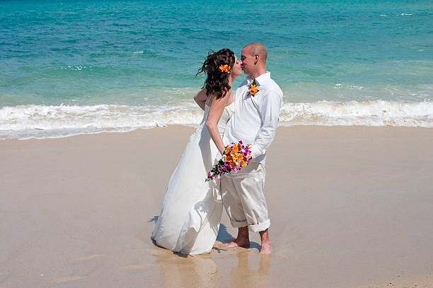 istock Bride and groom kissing on tropical beach 139859570