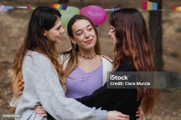 Young Lesbian Women In Polyamory Relationship Diversity Flags In Background Stock Photo - Download Image Now