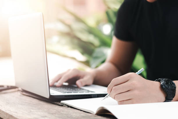 istock close up man studying online with laptop, Working from home. 1398596753