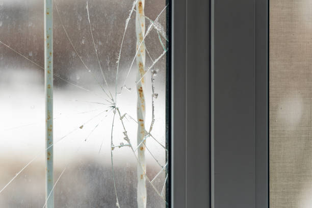 istock Glass broken by hooligans in a metal-plastic window, close-up 1398596858