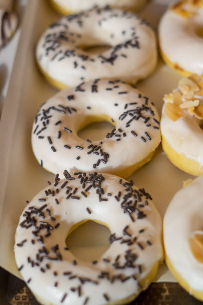 istock assorted donuts with chocolate frosted, pink glazed and sprinkles donuts. 1398598326