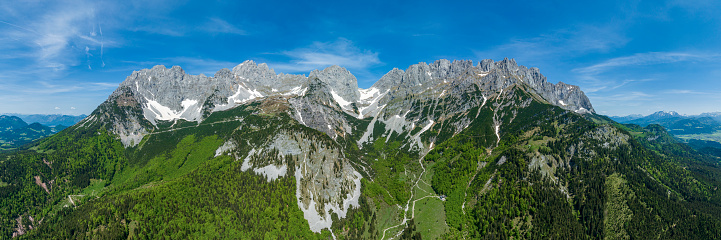 Idyllic summer landscape in the Alps with fresh green mountain pastures and snow-capped mountain tops in the background, Nationalpark Berchtesgadener Land, Bavaria, Germany