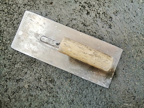 steel plastering trowel on cement
