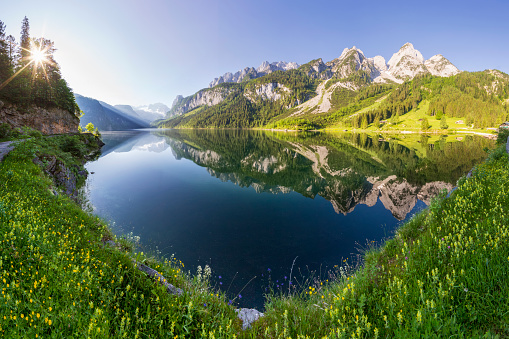 Fantastic autumn sunset of Hintersee lake. Beautiful scene of trees near turquoise water of Hintersee lake. Location: resort Ramsau, National park Berchtesgadener Land, Upper Bavaria, Germany Alps, Europe