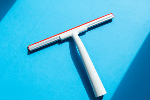 Rubber squeegee cleans window. Clears a stripe of soaped window. Cleaning service concept.