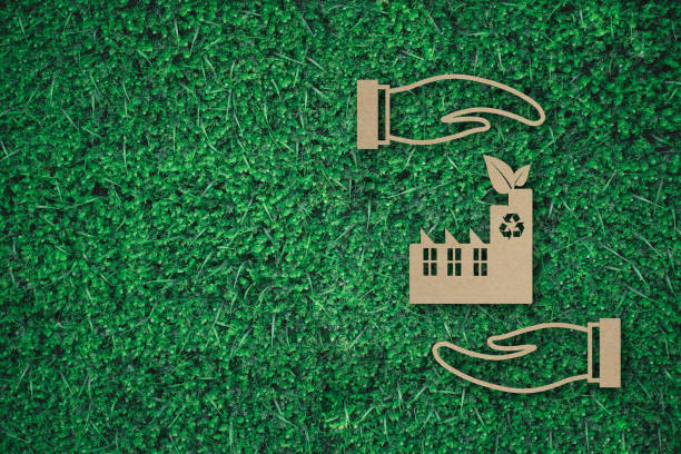 istock factory with leaf between business hands paper cut on green grass background with copy space , green energy iconic symbol, save energy concept 1398607619