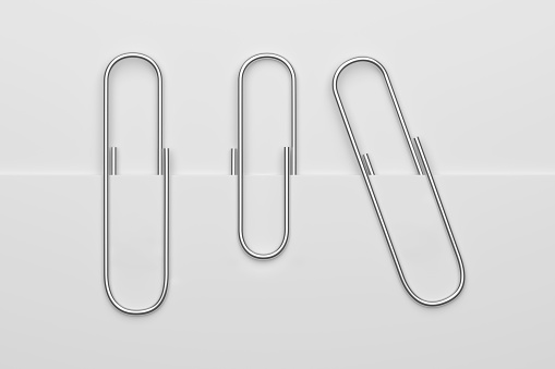 Silver paper clips attached to white paper. 3D rendering illustration.