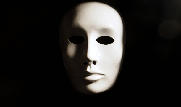 White face mask on dark background. White face mask on dark background. vendetta stock pictures, royalty-free photos & images