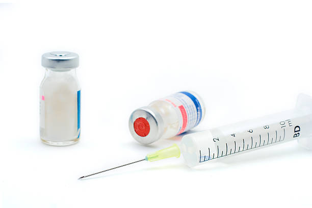 istock Syringe with medicine bottles on white background 139860990