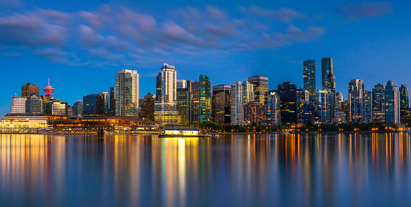 Night skyline of Vancouver downtown as seen from Stanley Park, British Columbia, Canada. Long exposure.
