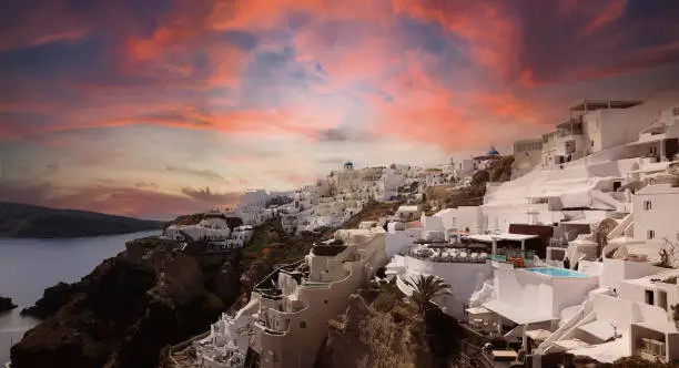 Photo of Sunset scene with blue dome church  at Oia village, Santorini,Greec