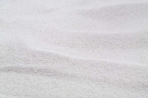 Brown sand close up. The texture of beach sand.