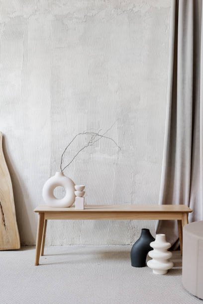 istock Ceramic vases with branches in room with textured walls 1398617527