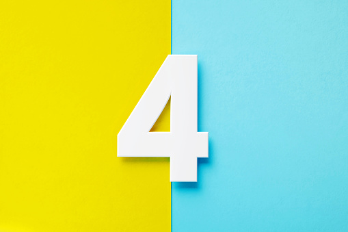 Extruded white number 4 sitting over yellow and blue background. Horizontal composition with copy space.