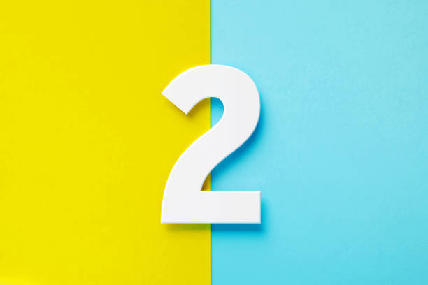 istock Extruded White Number 2 Sitting Over Yellow And Blue Background 1398618499