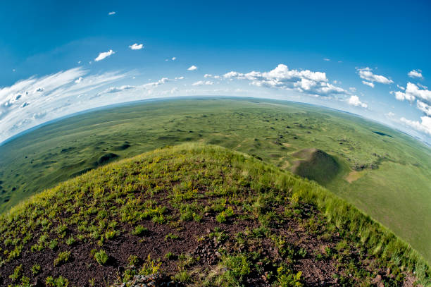 Curvature of the earth Fisheye view of the green grassland with Vullkan craters in the steppe of Mongolia, Central Asia horizon over land stock pictures, royalty-free photos & images