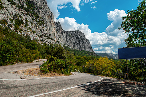 Summer sunny view of the Crimean road in the mountains. Beautiful mountain landscape of the Crimean Peninsula.