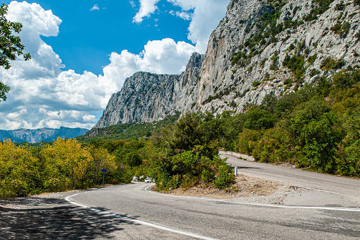 Summer sunny view of the Crimean road in the mountains. Beautiful mountain landscape of the Crimean Peninsula.