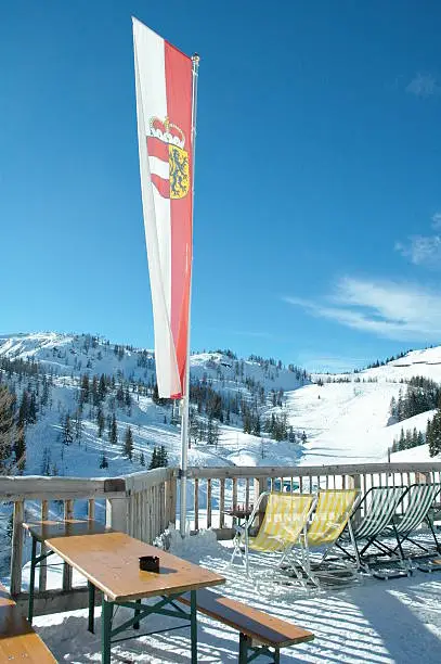 Restaurant in a skiarea in austria/flauchauwinkel with austria-flag in front of the sky