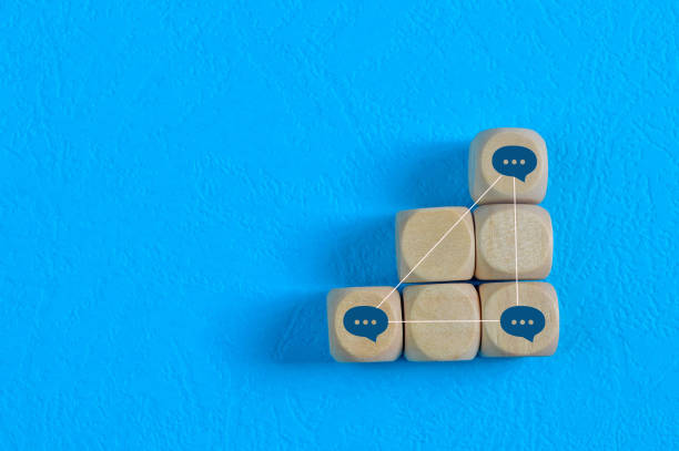istock Wooden blocks with speech bubble or chat linked to each others. Social networking and online communication concept. 1398621581