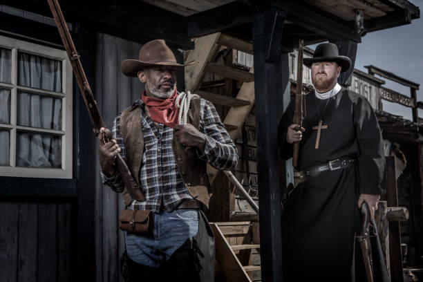 istock Handsome Black Cowboy with a priest in an authentic wild west setting 1398621631
